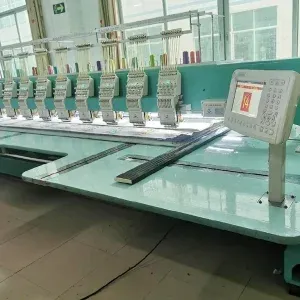 Interior view of a lace manufacturing factory showcasing advanced automated embroidery machines used for producing intricate lace patterns in bulk. Interior view of a lace manufacturing factory showcasing advanced automated embroidery machines used for producing intricate lace patterns in bulk.