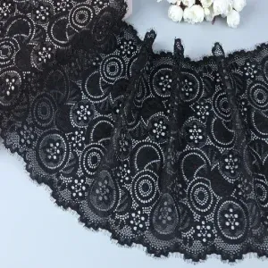 Close-up of black floral lace trim featuring intricate flower patterns, perfect for adding elegance to garments and home textiles. Close-up of black floral lace trim featuring intricate flower patterns, perfect for adding elegance to garments and home textiles.