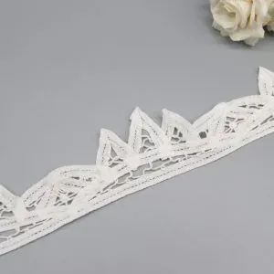 White 100% pure cotton eyelet lace with reinforced border stitching, perfect for dressmaking, baby clothes, and home textiles.