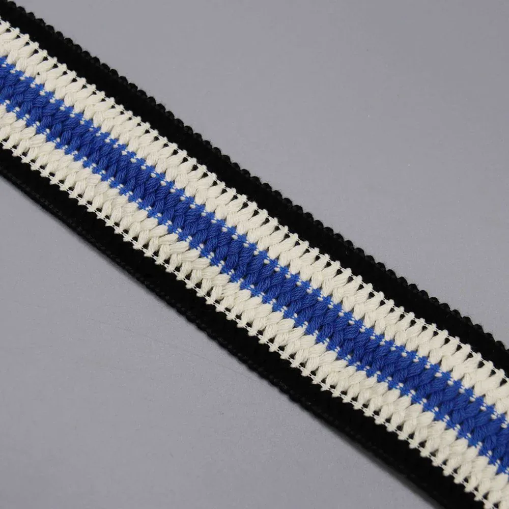 A straight diagonal length of black, white and blue striped trim. A straight diagonal length of black, white and blue striped trim.