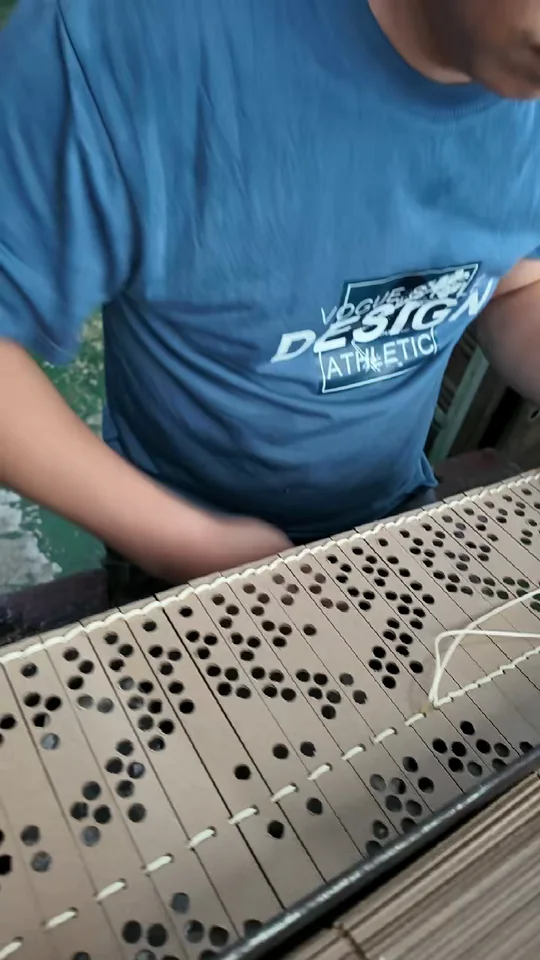 A team member joins the punched pattern cards.