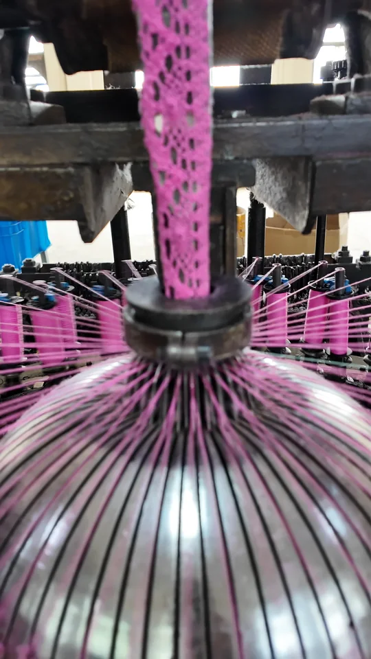 Pink lace takes shape as the machine runs.