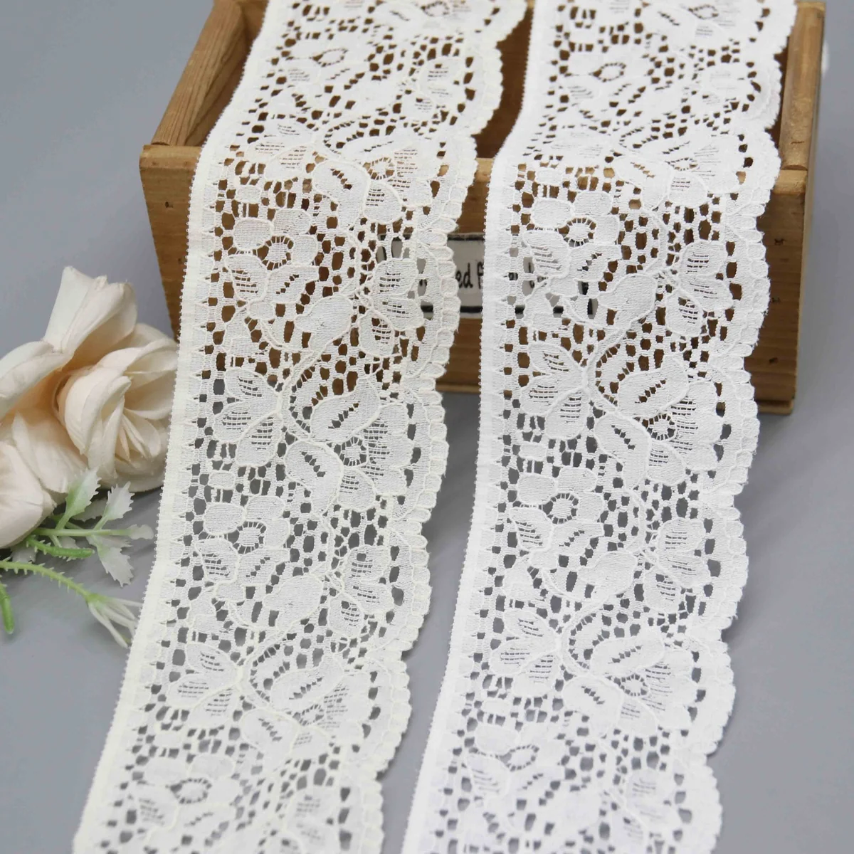 A Repeating Floral and Foliage Pattern On A Net Galloon Lace Trim for Lingerie