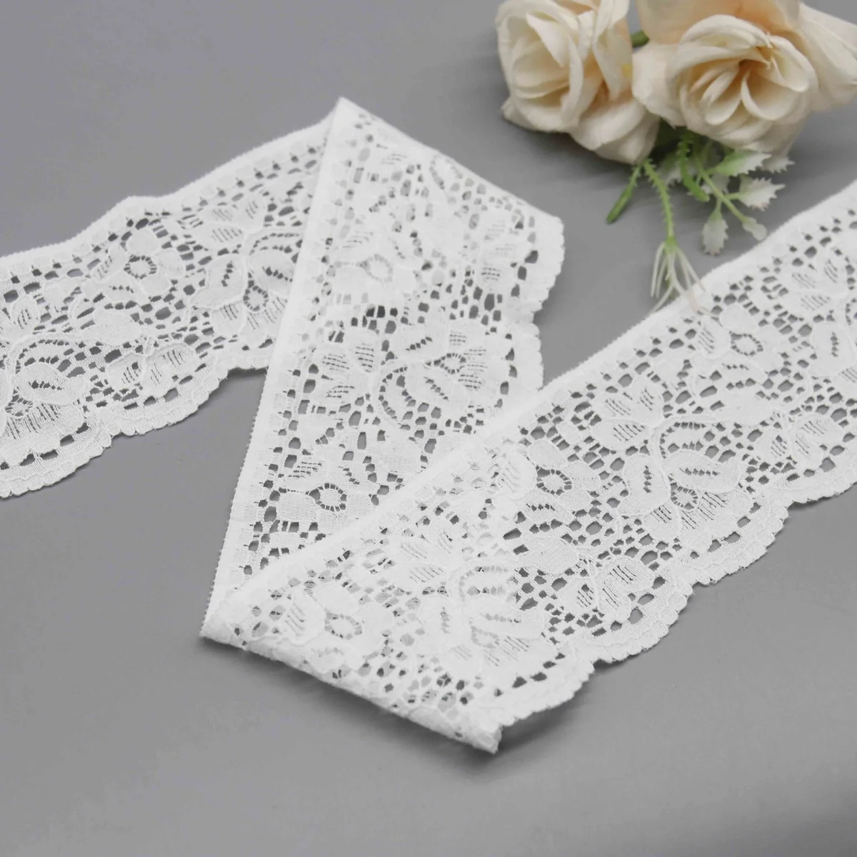 A Repeating Floral and Foliage Pattern On A Net Galloon Lace Trim for Lingerie