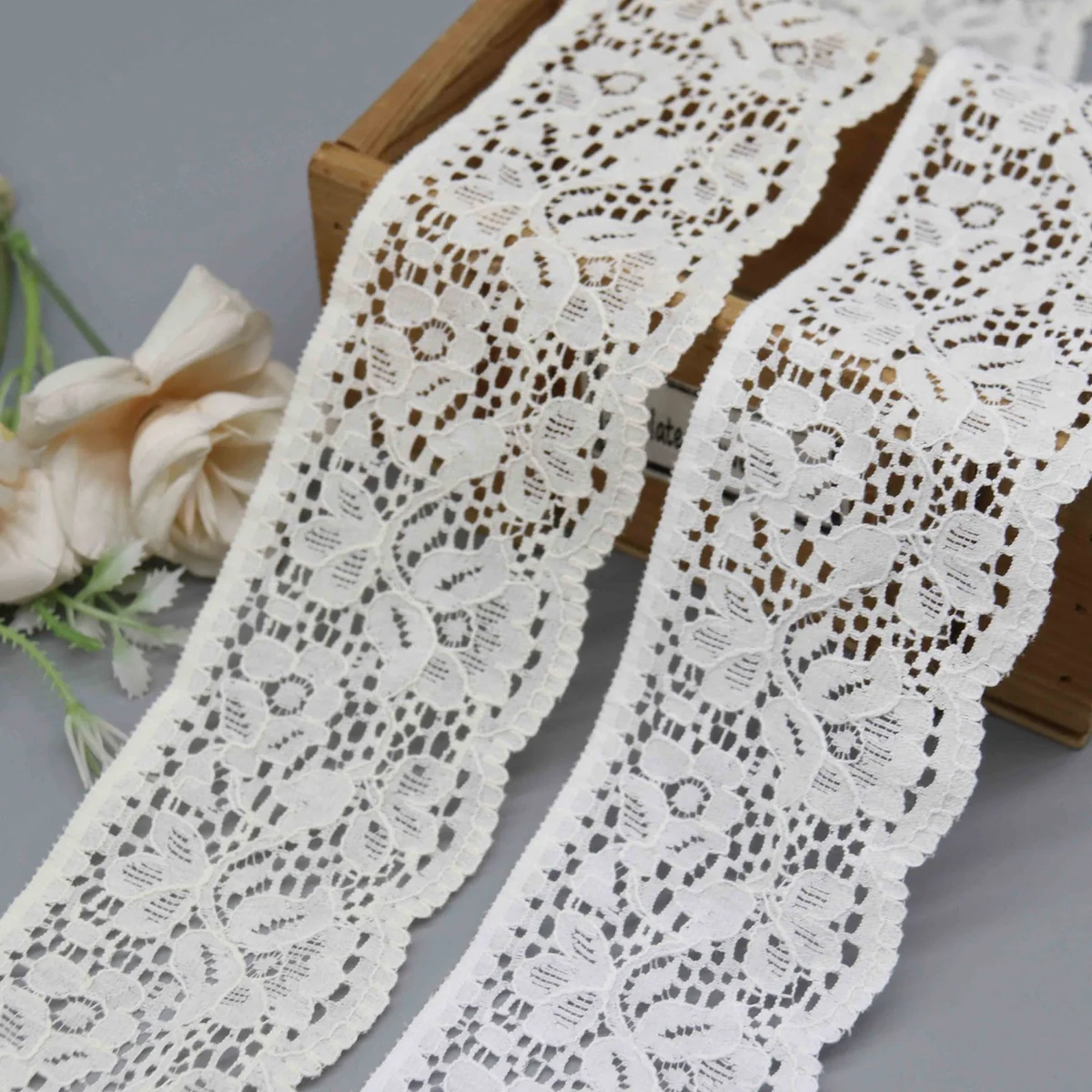 A Repeating Floral and Foliage Pattern On A Net Galloon Lace Trim for Lingerie