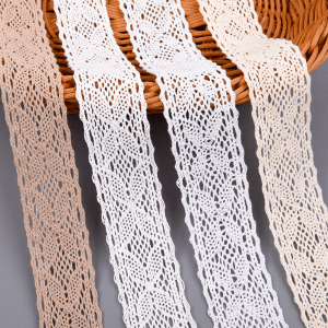 Assorted colors of cotton lace trims with intricate crochet patterns displayed on a woven basket.