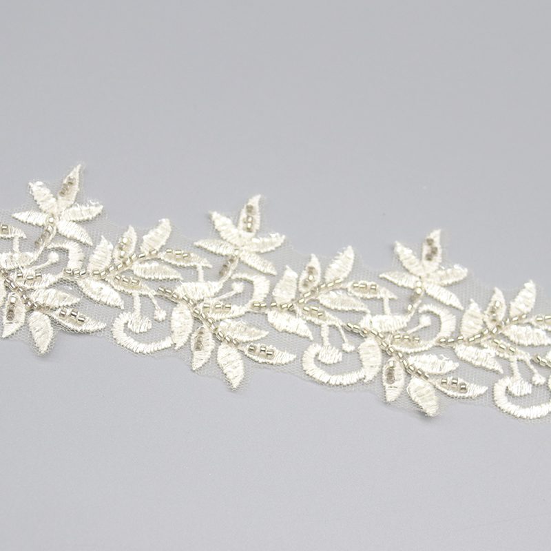 Multicolored handmade embroidered lace trim with sequin and bead accents, made with eco-friendly materials.