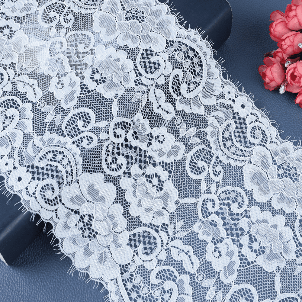 Soft ivory vintage lace in a polyester–cotton blend with Chantilly-look florals, ideal for bridal overlays and sleeve trims.