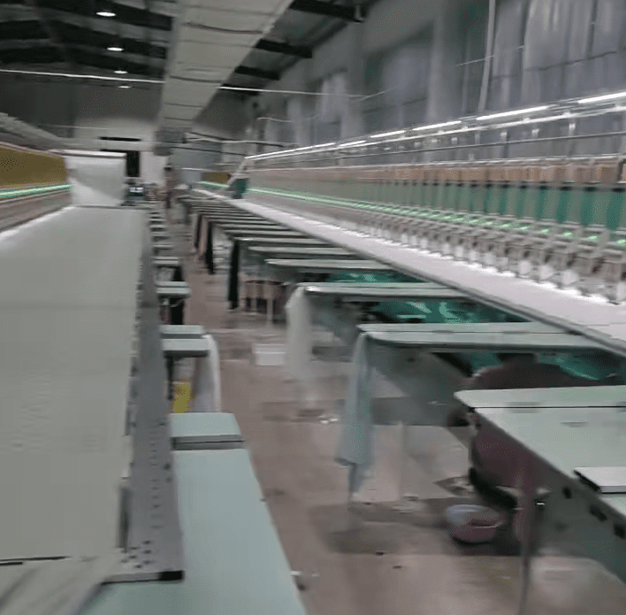 Production hall showing dedicated lines for water soluble embroidery and chemical lace etching to support custom orders.