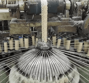 Interior view of a state-of-the-art cotton thread lace factory using automated embroidery systems for precise lace production. 