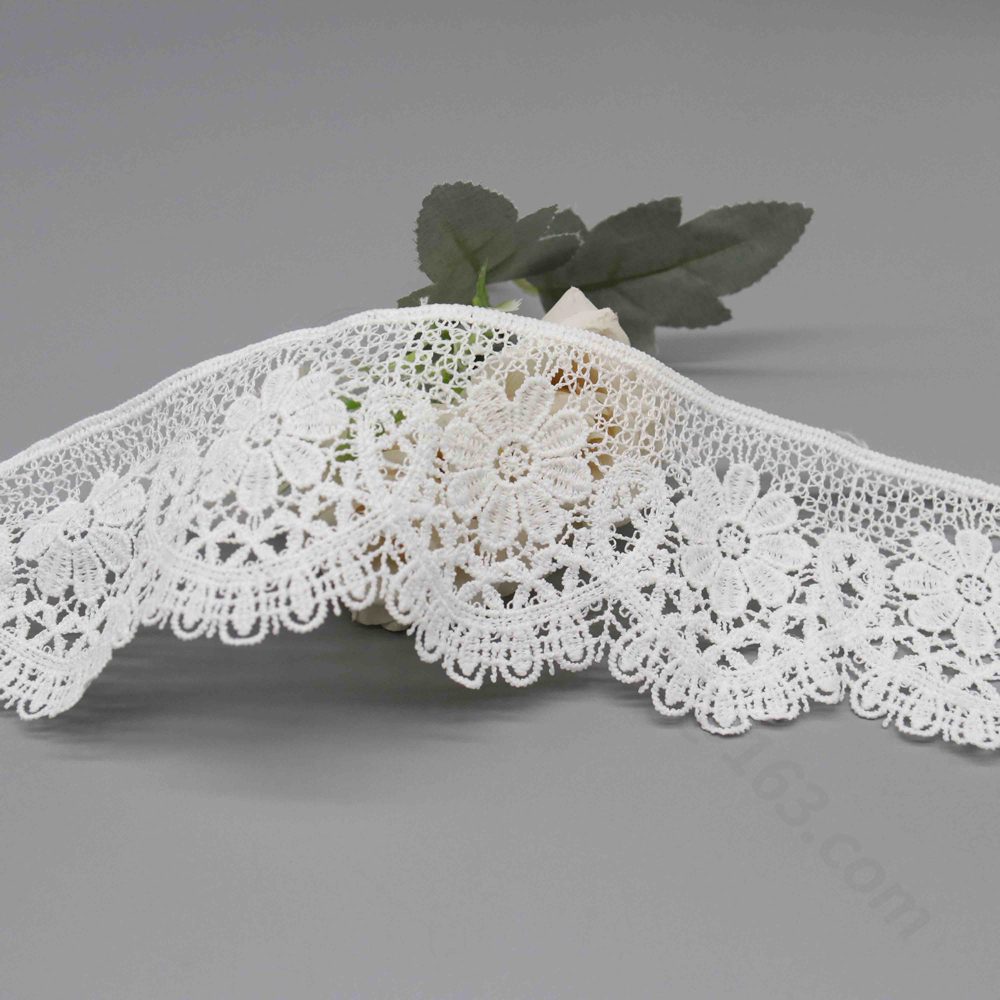 Sophisticated display of stock snow white water-soluble polyester lace trim using hollow Guipure craft, with elaborate floral and geometric embroidery offering pronounced layering and wave edge contours; soft texture suits high-end applications in skirt borders, collar detailing, and bag sophistication.