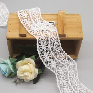 High-resolution image of pure white customizable French lace trim showcasing exquisite embroidery with stereoscopic geometric round motifs filled with radiating petals on a delicate mesh foundation; fine layered craftsmanship and subtle wave edges elevate garment accessories with luxurious detail.