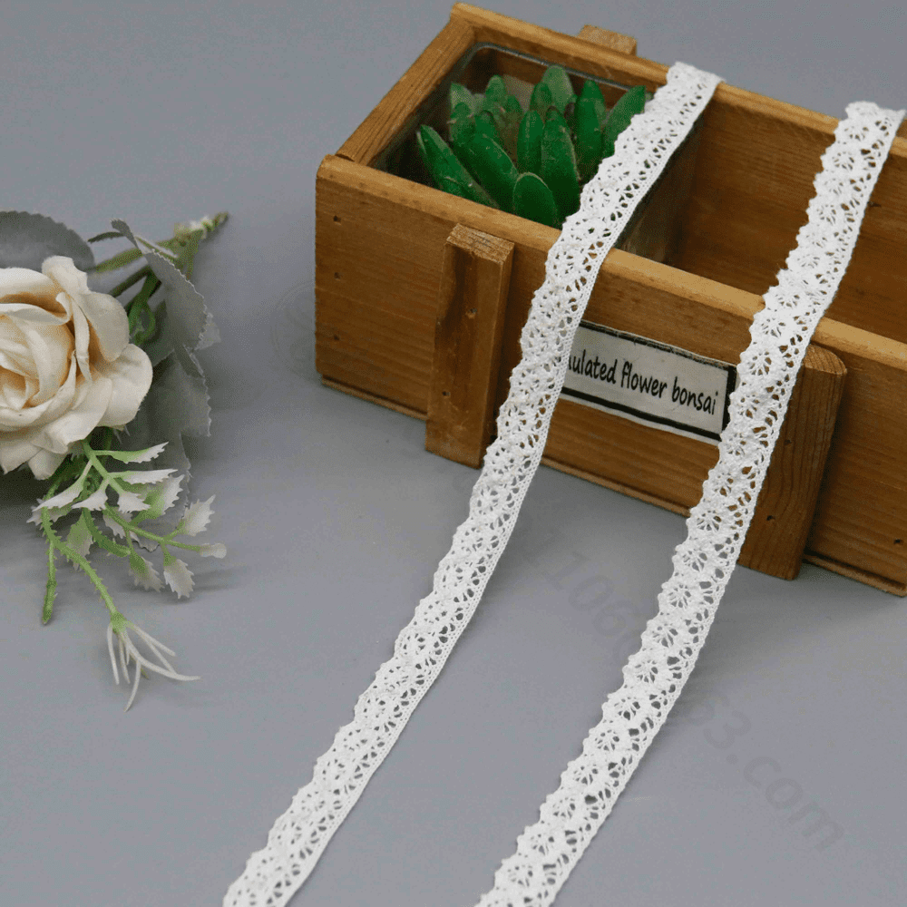 Close-up of soft cotton thread lace trim featuring an elegant floral pattern, ideal for enhancing fashion accessories and garments.