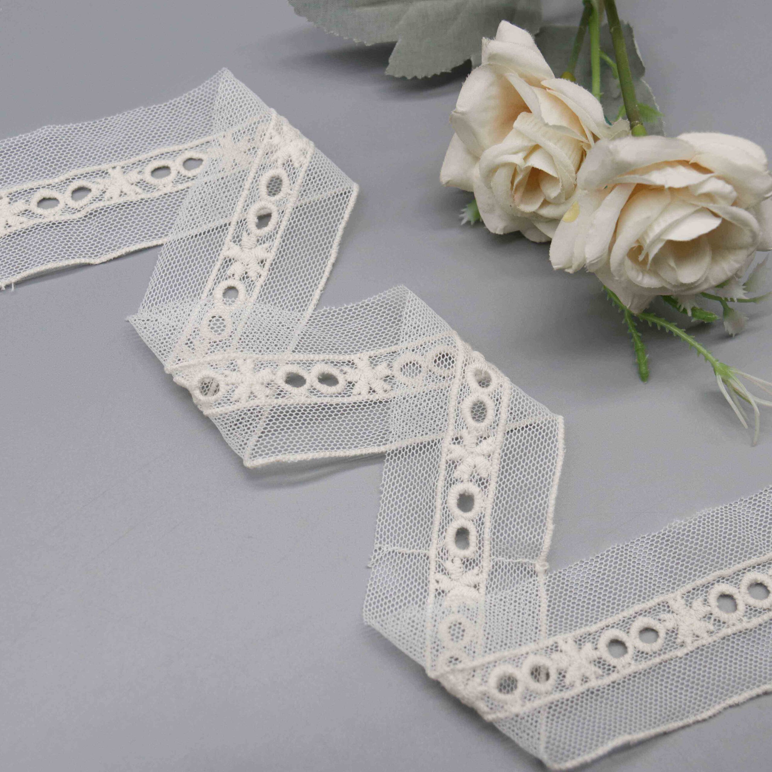 Backlit shot demonstrating the transparency of the tulle ground and eyelet openwork density.