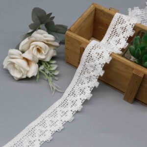 Front-facing shot showing the triangular mesh openwork and loop fringe border clearly.