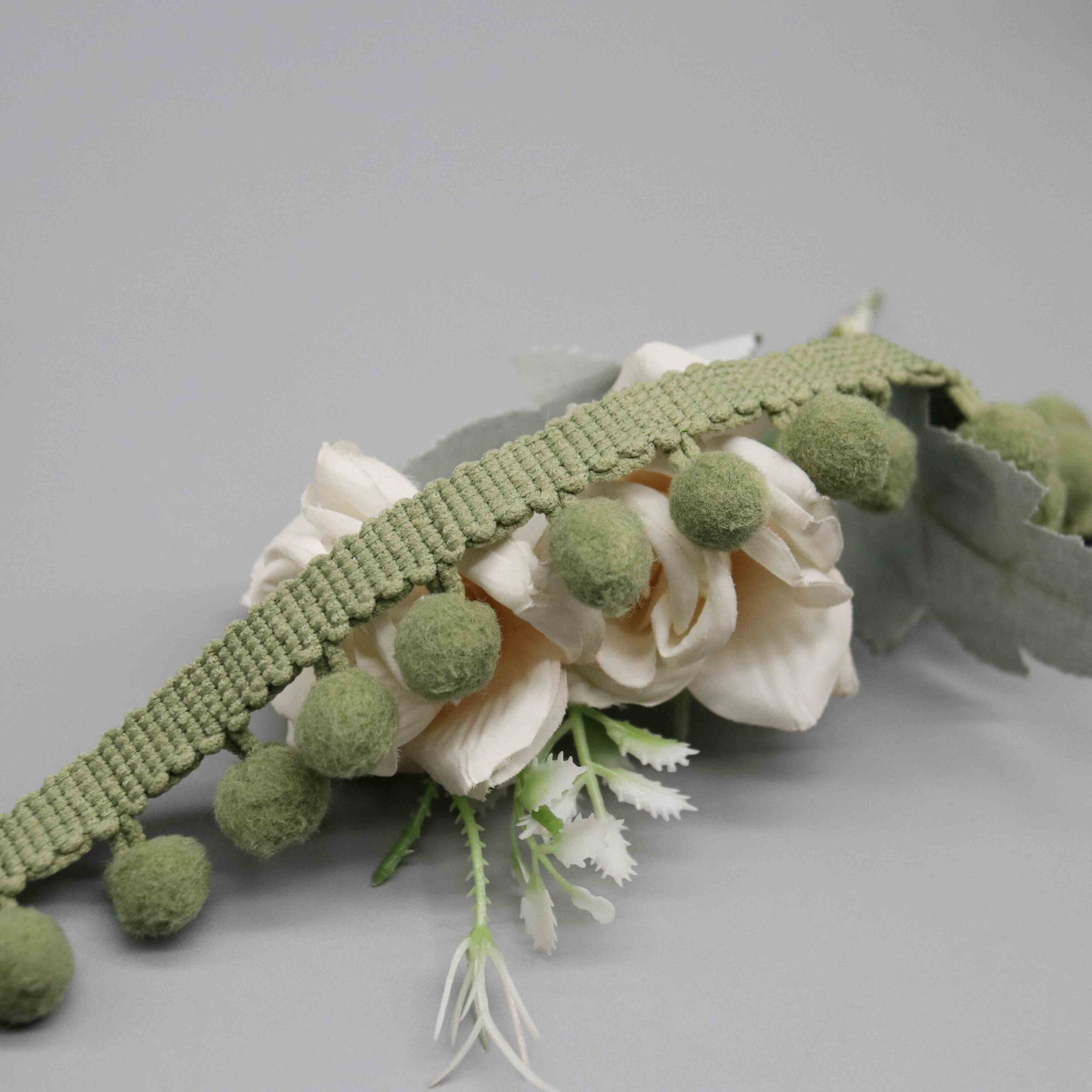 Angled shot capturing the woolly matte nylon texture and natural fuzzy appearance of pompoms.