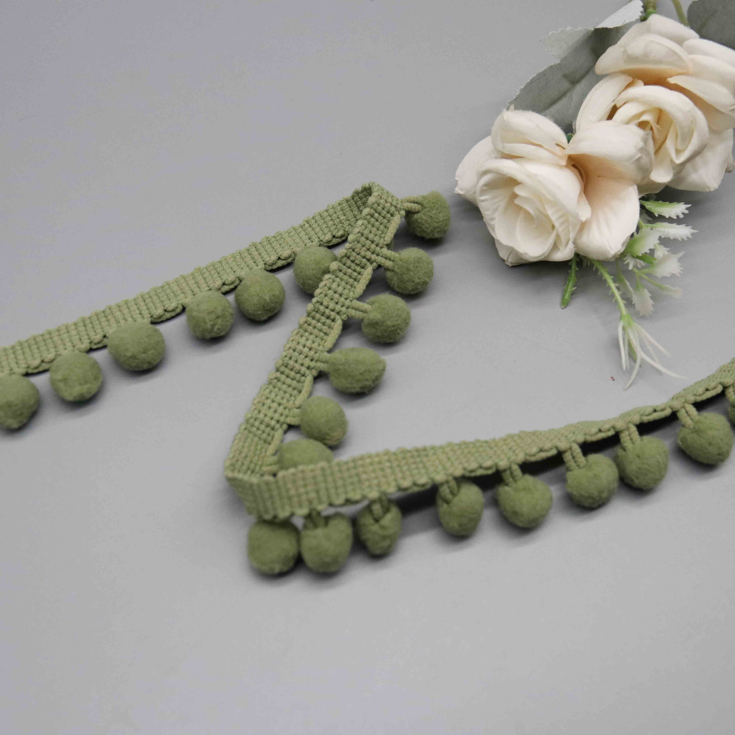 High-resolution detail showing the decorative braided header band with raised bobble trim accent.