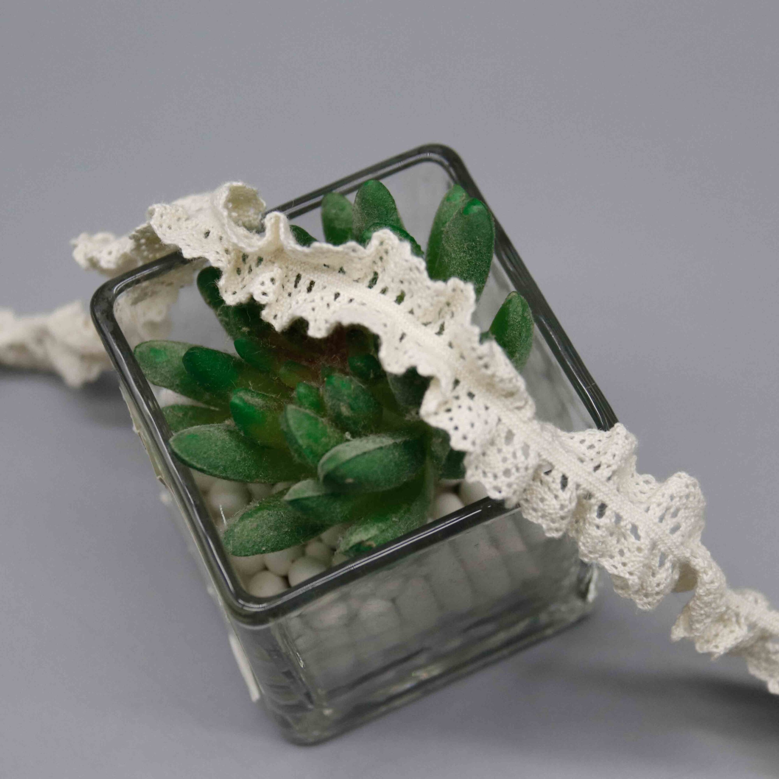 Macro close-up capturing intricate openwork construction and gathered wave craftsmanship.