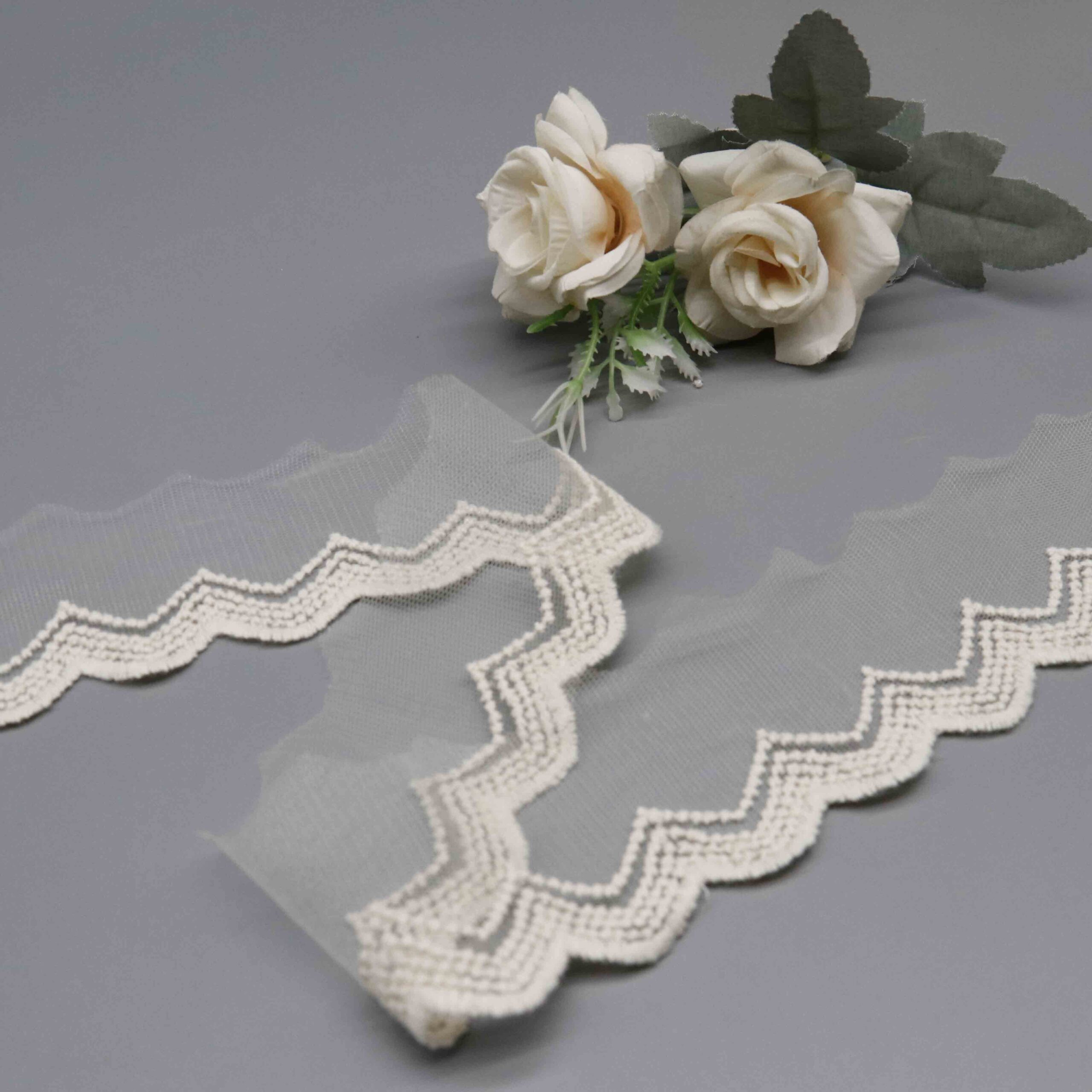 Macro close-up of the double-layer chevron embroidery with textured fill stitching on mesh base.