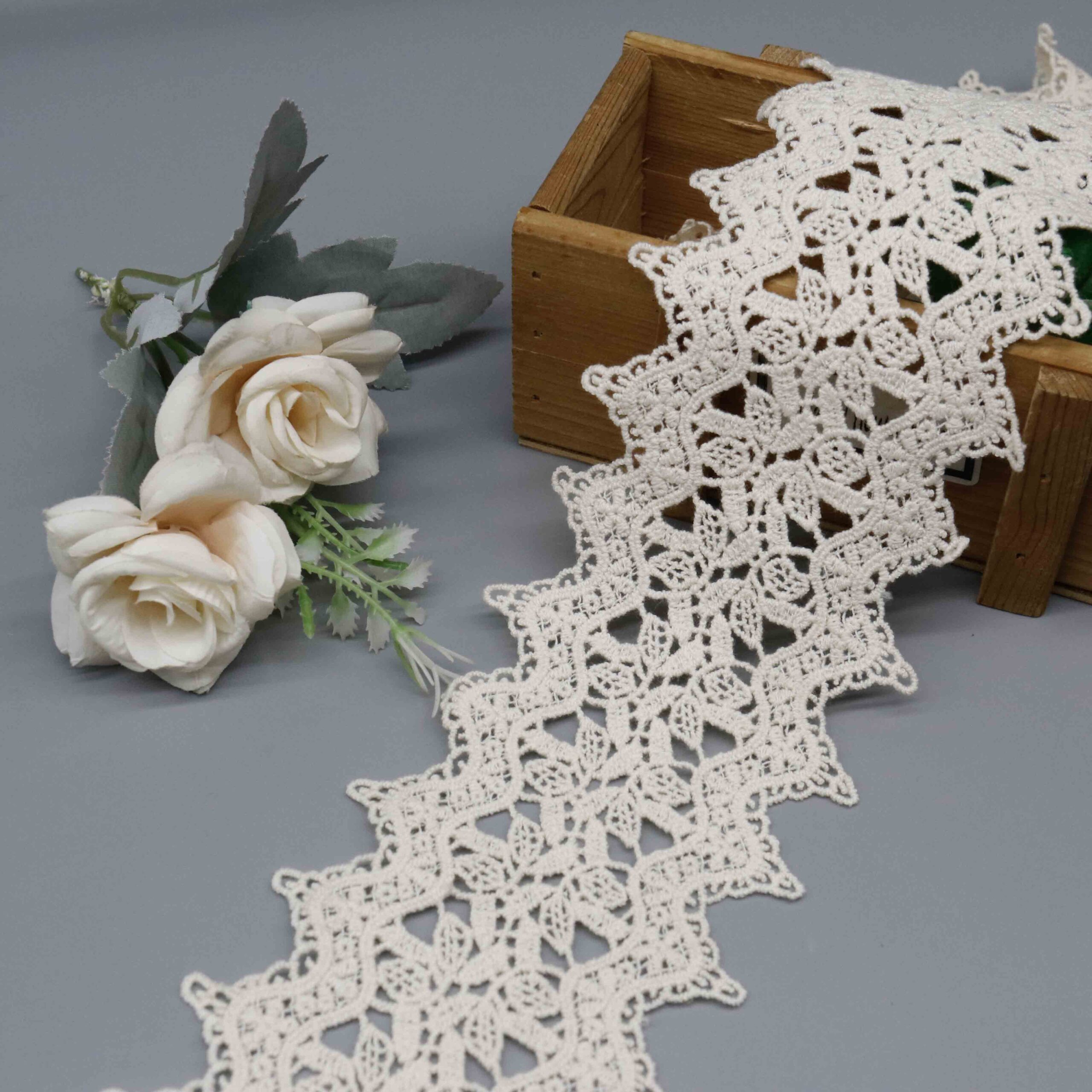 Front-facing shot showing geometric trellis pattern and natural matte cotton texture on cream embroidered lace.