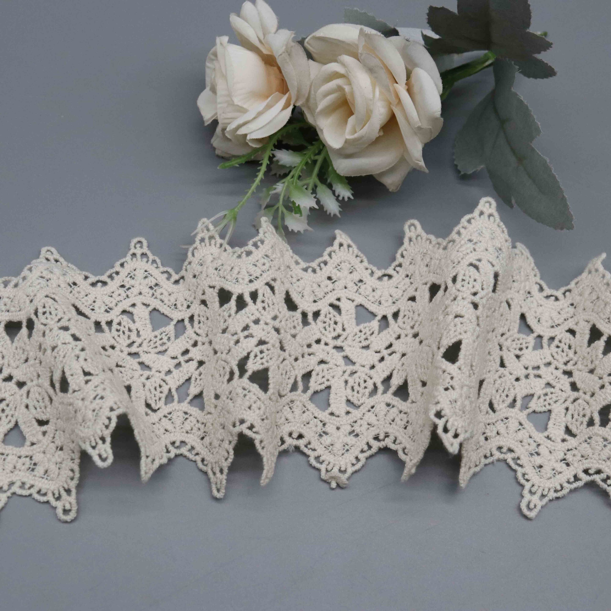 Backlit demonstration of lattice embroidery density and airy see-through characteristics through fabric mesh.