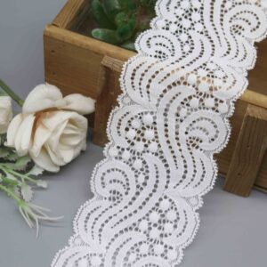 A studio shot of a 6cm wide stretch lace, model HDL-1402, featuring a bold, modern swirl pattern and symmetrical scalloped edges