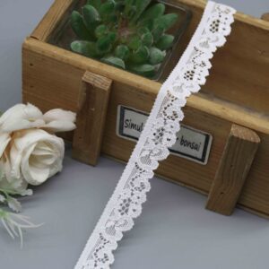 A studio photo of model HDL-1098, a 1.7cm narrow elastic lace, showing its delicate floral scallop edge, perfect for lingerie trims