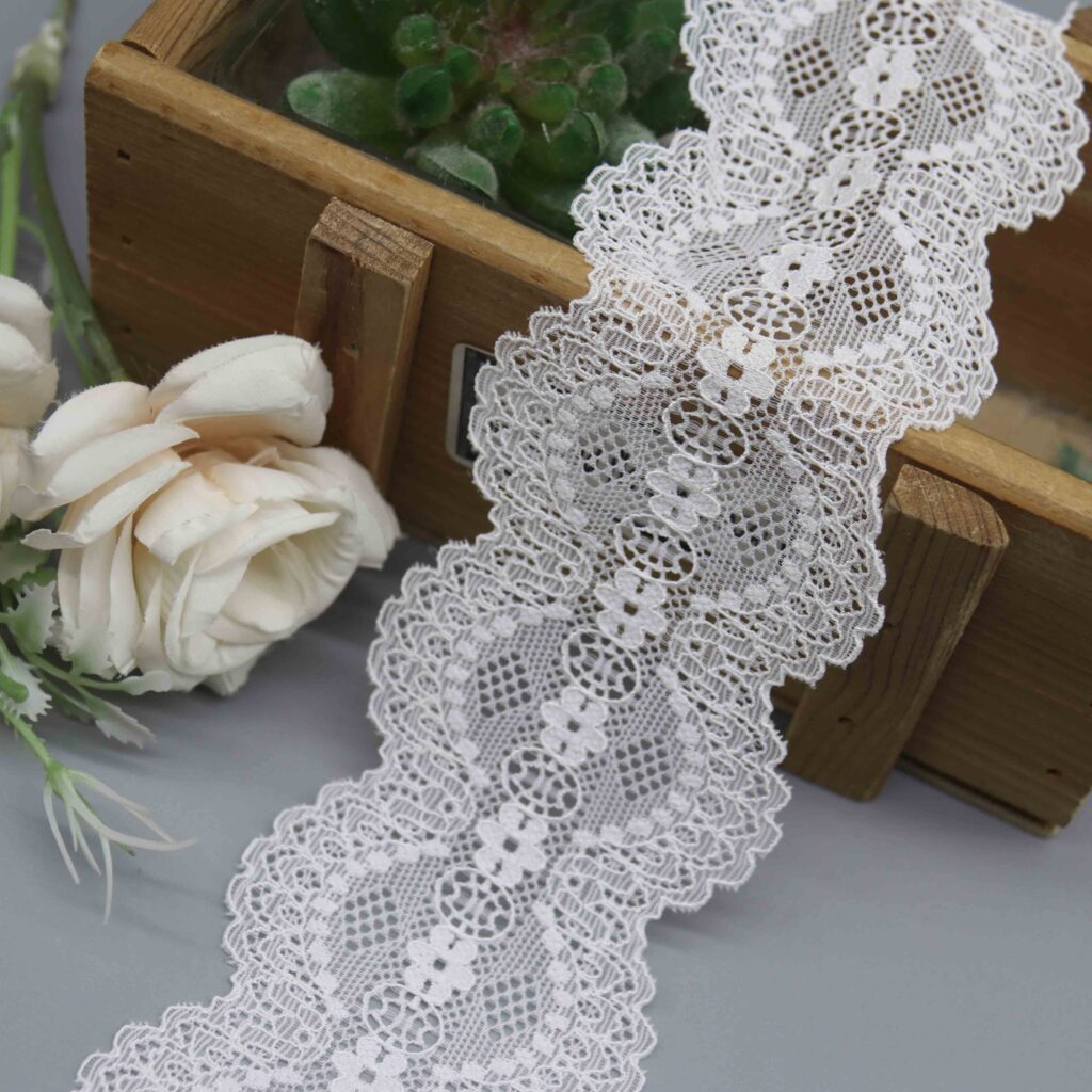 a 6cm wide galloon lace in white with a symmetrical vintage medallion pattern.