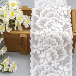 Close-up of a new design white floral elastic lace trim, featuring soft, delicate fabric with full, layered flower patterns and elegant wave-shaped edges; ideal for adding romantic refinement to underwear, clothing, and handmade DIY decorations.