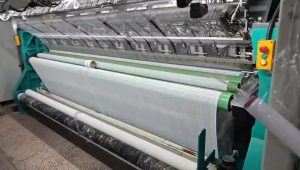 High-speed lace trim weaving machine operating in a modern lace factory, demonstrating precise and efficient automated lace production.