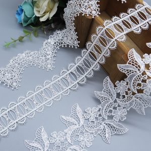White polyester water soluble lace trims featuring flower and eyelet fabric designs, perfect for garment embellishment.