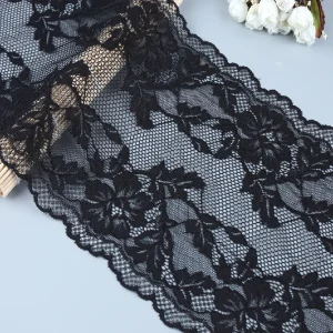 High-quality soft black lace trim adorned with intricate floral motifs, suitable for enhancing clothing and accessory designs.