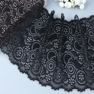 Close-up of black floral lace trim featuring intricate flower patterns, perfect for adding elegance to garments and home textiles.