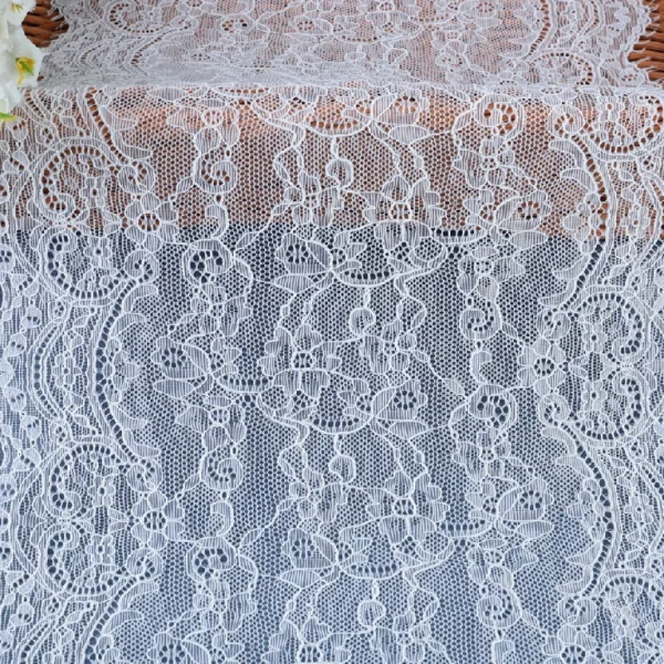 Flexible and beautifully designed mesh lace trim blending nylon and spandex, ideal for use in wedding dress crafting.