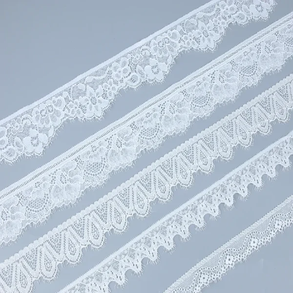Soft and flexible Chantilly stretch lace trim, blended with nylon and spandex, ideal for adding luxury to dresses and gowns.
