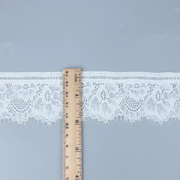 Soft, elastic Chantilly lace trim made of 90% nylon and 10% spandex, ideal for stylish dress designs and garment decoration.