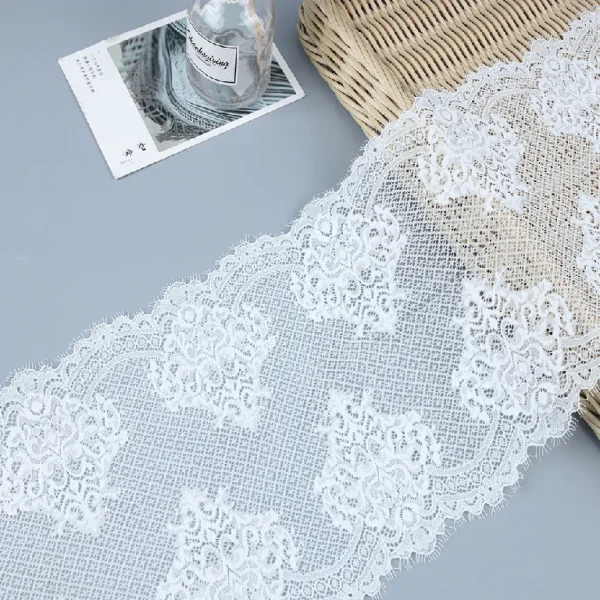 Delicate eyelash French lace trim made with 90% nylon and 10% spandex, suitable for fancy accents on apparel and clothing.