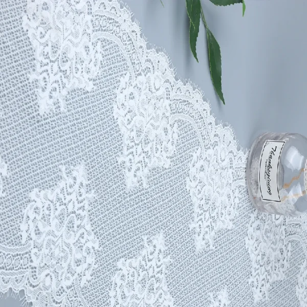 Latest eyelash French lace trim featuring a blend of nylon and spandex, adding style and stretch to contemporary apparel designs.