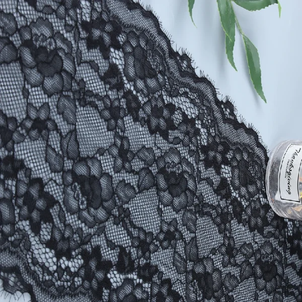 Black eyelash lace trim with intricate floral and wavy designs, approx. 21 cm wide, suitable for fashion and decor.