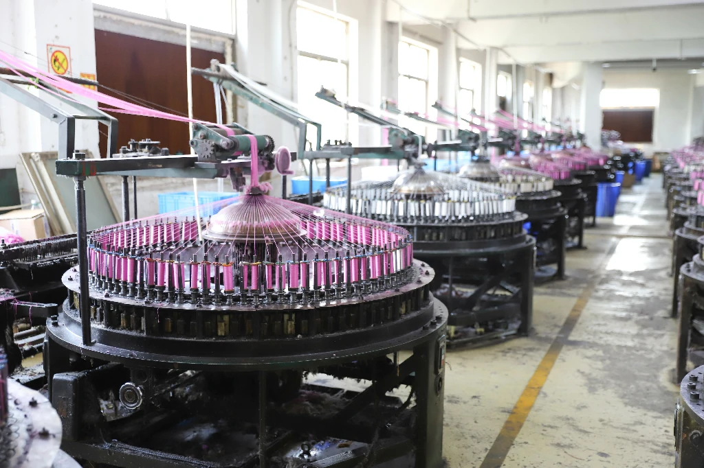 Technician performing quality checks on lace during factory production.