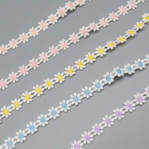 Sophisticated display of polyester water-soluble lace trim with a string of elegant daisies featuring white petals and cheerful pink, yellow, blue, or purple centers; refined crochet work provides a 3D, whimsical effect, versatile for yard-by-yard use in wedding florals, photography scenes, and apparel embellishments.