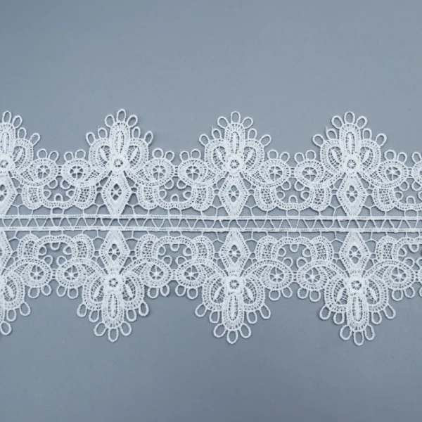 White wide French lace trim made from 100% polyester, water soluble, ideal for luxury garment embellishments.
