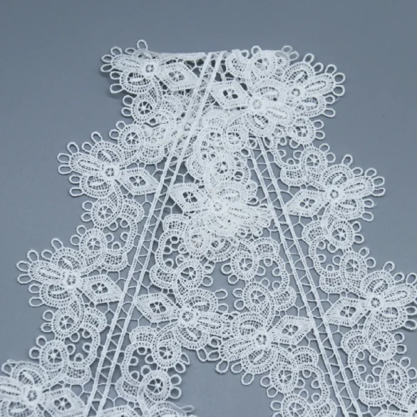 Wide white French lace made from 100% polyester, water soluble and perfect for luxury garment decoration.