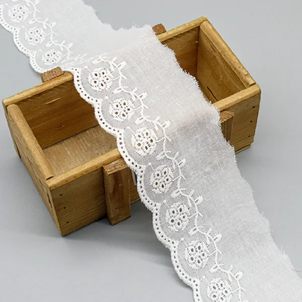 Elegant embroidered cotton lace trim made for bulk wholesale, featuring premium quality and custom factory designs for dresses and décor.