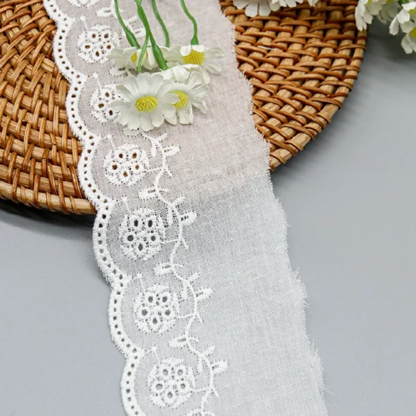 Soft and luxurious premium cotton embroidered lace trim available for wholesale, suitable for bridal wear and home décor embellishment.