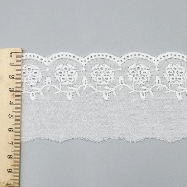 Bulk wholesale of premium cotton lace trim with embroidered details, ideal for elegant bridal gowns and sophisticated home décor.