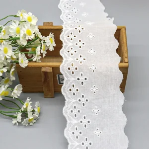 Elegant pure cotton eyelet lace trim featuring floral embroidery, hot selling choice for customizing garments and fashion items.