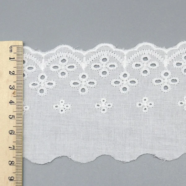 Premium pure cotton lace trim with intricate embroidered flowers and eyelets, widely favored for apparel design and decoration.