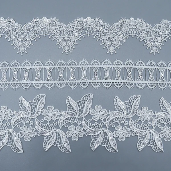 White Water Soluble Lace Trim with 100% Polyester Flower Eyelet Design for Garment Embellishment.
