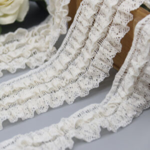 Close-up of innovative 2025 French lace in pure white, showcasing advanced mesh crochet with elegant wave-folded layers and vivid 3D texture for a sophisticated French flair; soft, elastic, and eco-friendly, ideal for bulk yard wholesale in shoe and bag decoration.